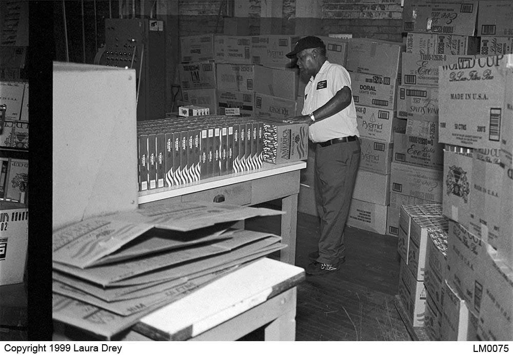 image of employee preparing returned goods for the carton saw
