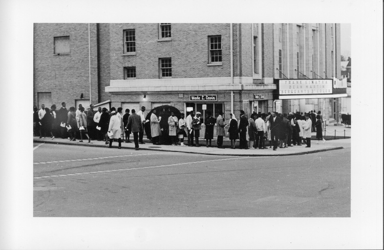 A long line of black people outside the Carolina Theatre. 