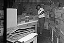 thumbnail of employee preparing returned goods for the carton saw