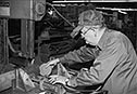 thumbnail of machinist operating cut-off saw
