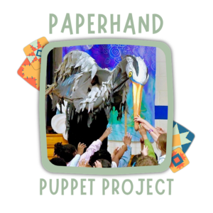 A group of children reach their hands toward the bill of a majestic larger-than-life bird puppet.