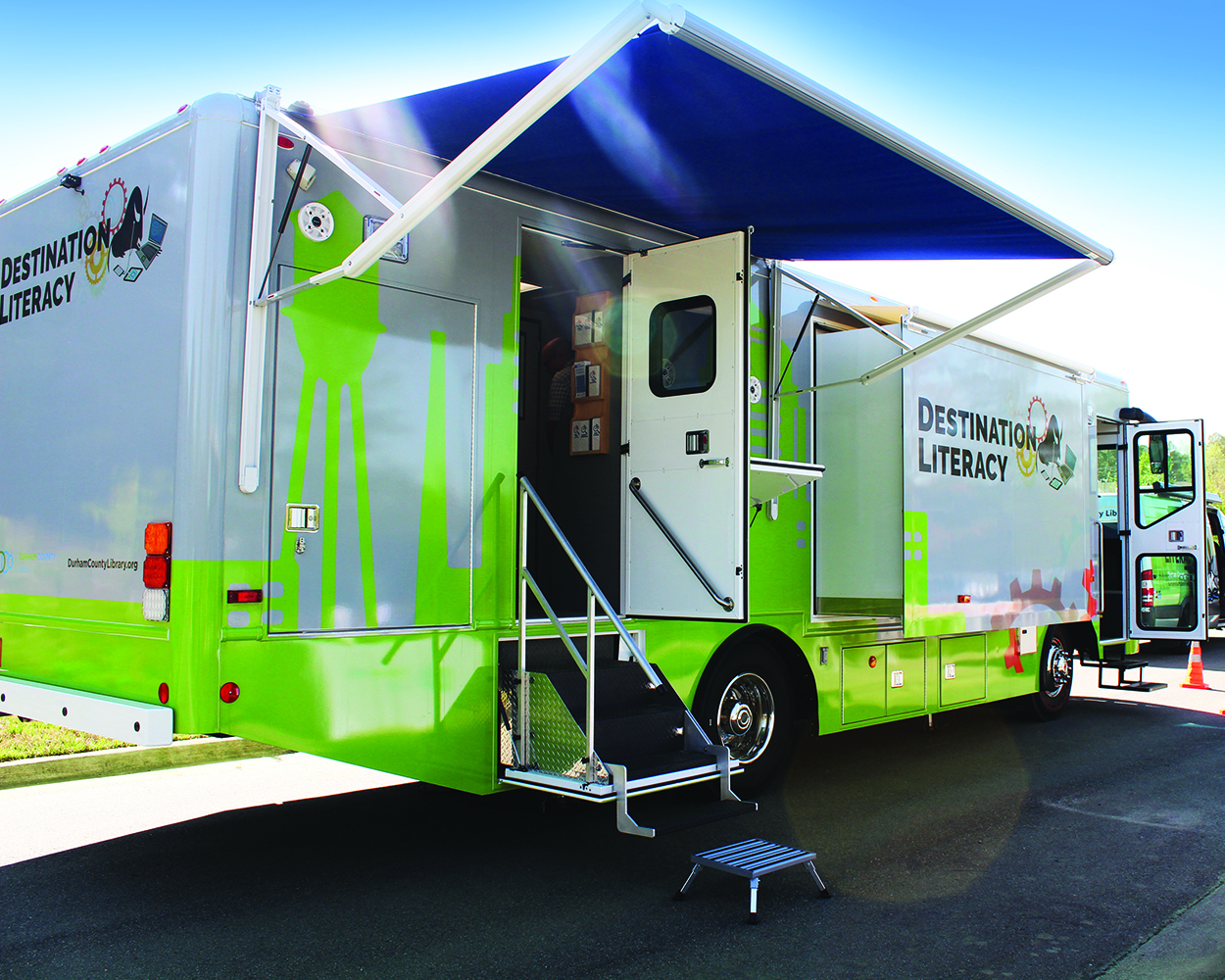The Tech Mobile: a large vehicle with open doors and extended canopies