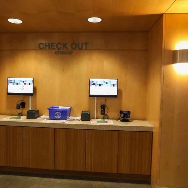 Counter with two screens in an alcove labeled "check out"