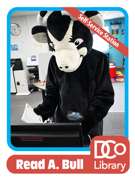 Costumed mascot Read A. Bull stands at a monitor and uses a scanner to check out a book